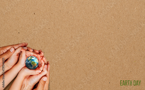 Build a beautiful World. Globe in the hands. Earth Day concept. brown background with copy space. 3d rendering © suman