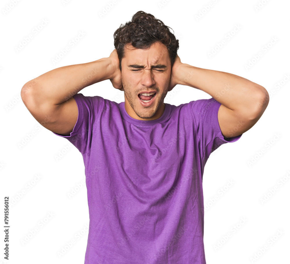 Young Hispanic man in studio covering ears with hands trying not to hear too loud sound. Young Hispanic man in studio covering ears with hands trying not to hear too loud sound.