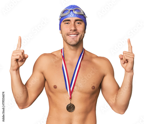 Hispanic male swimmer with gold medal celebrating victory photo