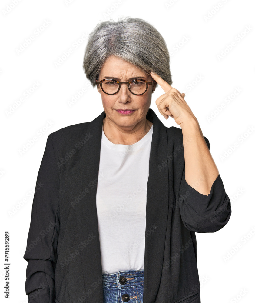 Caucasian mid-age female in business suit pointing temple with finger, thinking, focused on a task. Caucasian mid-age female in business suit pointing temple with finger, thinking, focused on a task.