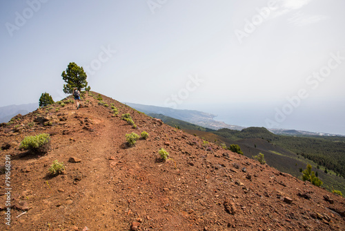 A young woman walking towards Birigoyo peak, La Palma Island, Canary Islands. photo