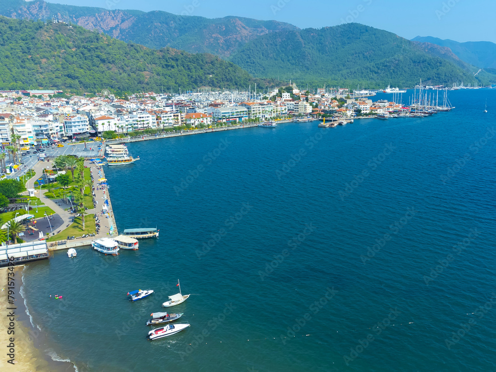Panoramic view of Marmaris city from a drone on a sunny day, Turkey. Beautiful urban landscape of Marmaris, sea, mountains, beach.
