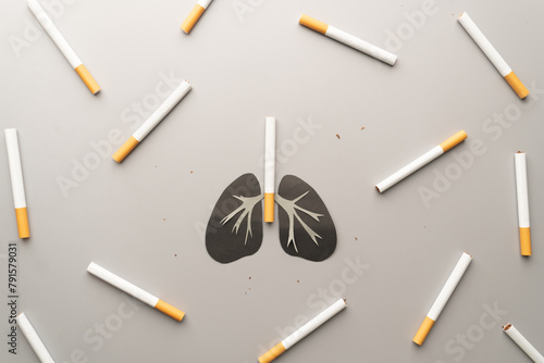 Unhealthy lung organ with cigarettes or tobacco on gray background. Lung diseases caused by smoking include COPD, asthma attack and lung cancer. World no tobacco day concept template.
