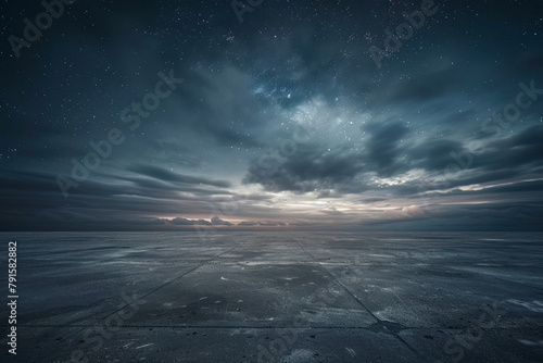 Dark Concrete Floor Background with Scenic Night Sky Horizon and Dramatic Clouds.