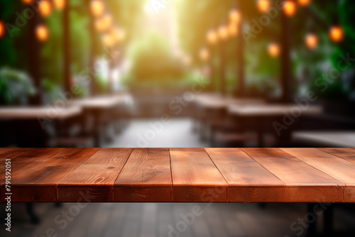 Empty wooden table in front green garden blurred background banner for product display in a coffee shop, local market or bar
