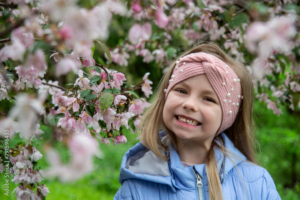 a little girl in a blossoming apple orchard a little girl in a blossoming apple orchard