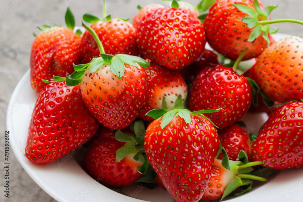 fresh strawberries. Fresh red strawberries lie on a white deep plate, top view close-up fruit concept fresh strawberries. Fresh red strawberries lie on a white deep plate, top view close-up fruit concept