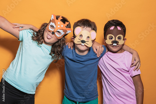 Playful children wearing animal masks in studio photo