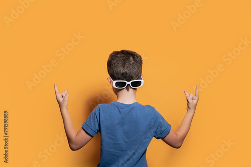 Cool boy showing peace sign in studio photo