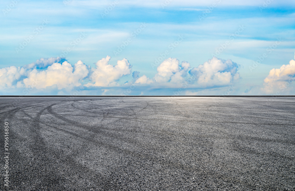 Asphalt road square with sky clouds background
