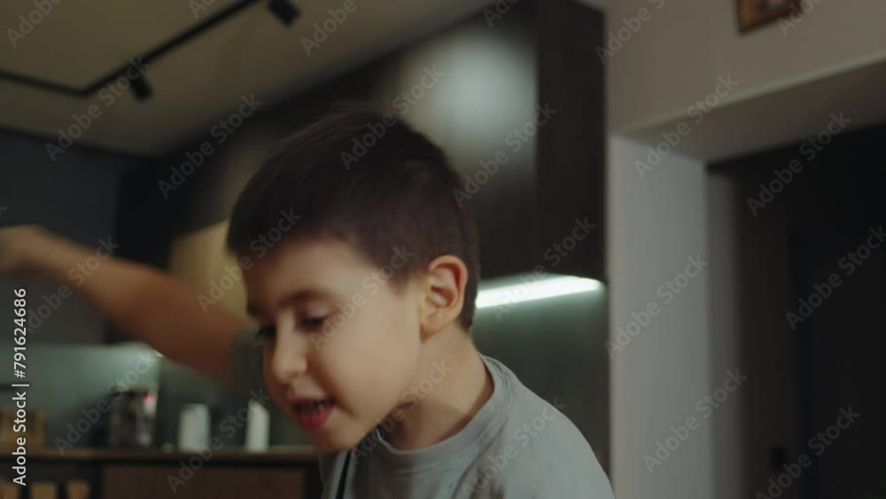 Boy playing an imaginary game by himself, gesticulating with atitude and talking, moving his mouth. Boy playing an imaginary game by himself, gesticulating with atitude and talking, moving his mouth.