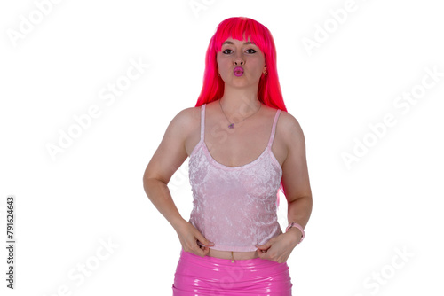 Woman dressed like a doll. Young beautiful sexy woman in camisole and pink skirt on white background. Red hair girl wears pink wig with fringe. Showing emotions. Sending air kisses