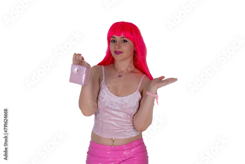 Woman dressed like a doll holds tiny small handbag. Young beautiful sexy woman in camisole and pink skirt on white background. Red hair girl wears pink wig with fringe. Shopping addict
