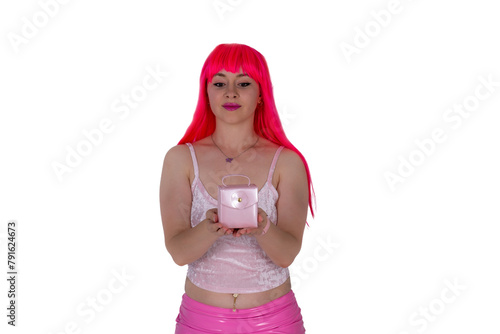 Woman dressed like a doll holds tiny small handbag. Young beautiful sexy woman in camisole and pink skirt on white background. Red hair girl wears pink wig with fringe. Shopping addict