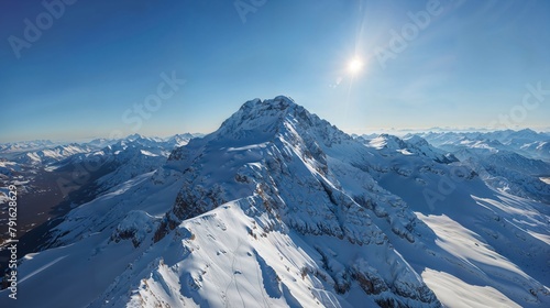 Snowy mountain slope in aerial view white landscape under blue sky