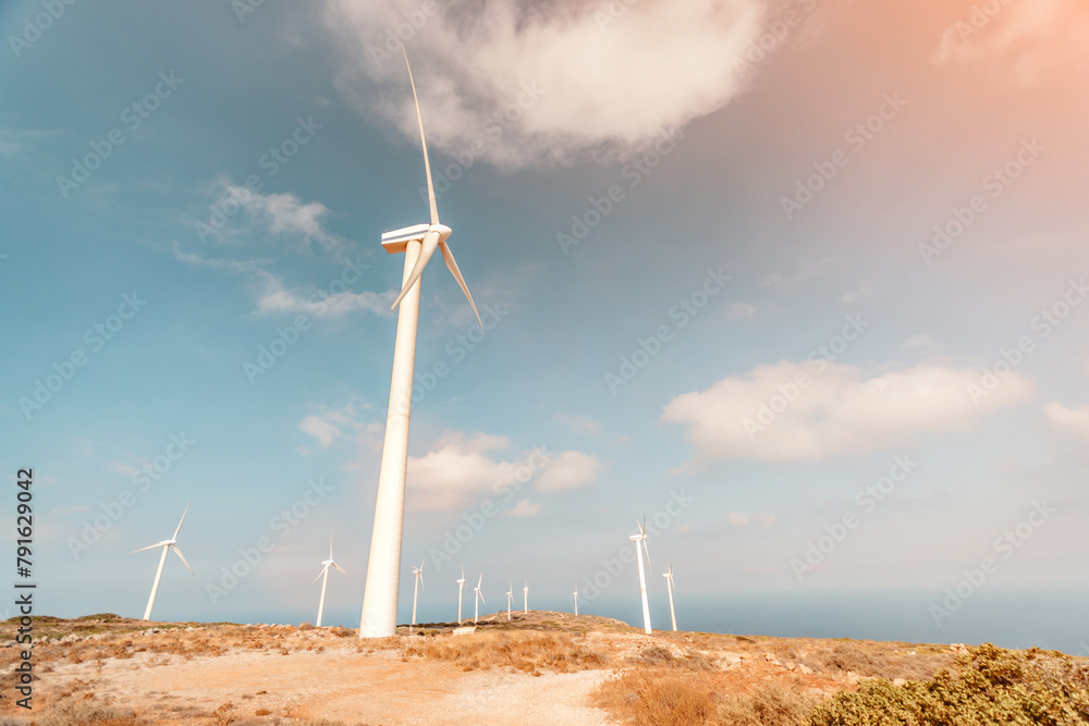Wind turbines on beautiful sunny mountain landsape. Green power generation concept. Wind turbines on beautiful sunny mountain landsape. Green power generation concept.