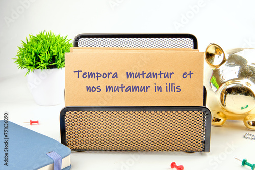 Tempora mutantur et nos mutamur in illis Translated from Latin, it means Times are changing, and we are changing with them. on the mustard-colored card photo