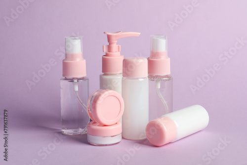 Cosmetic travel on violet background. Bath accessories