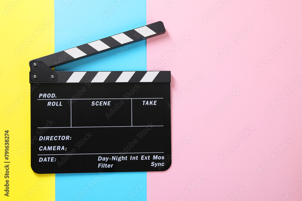 Obraz premium Clapperboard on color background, top view. Space for text