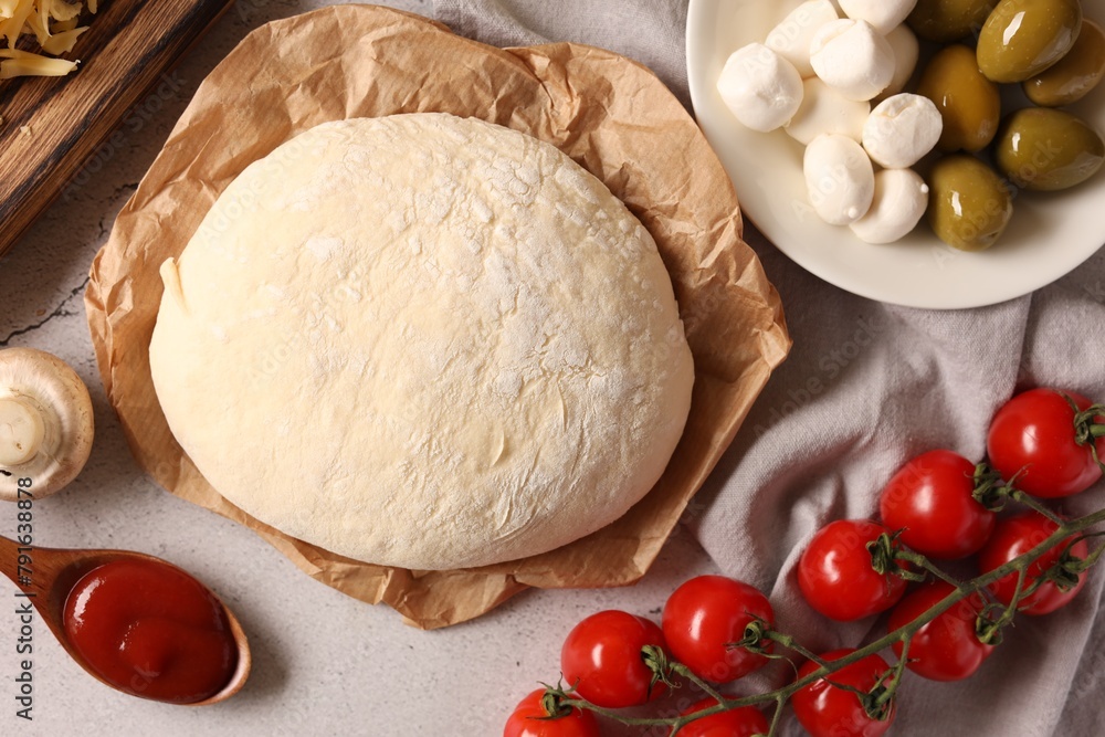 Pizza dough and products on gray textured table, flat lay Pizza dough and products on gray textured table, flat lay