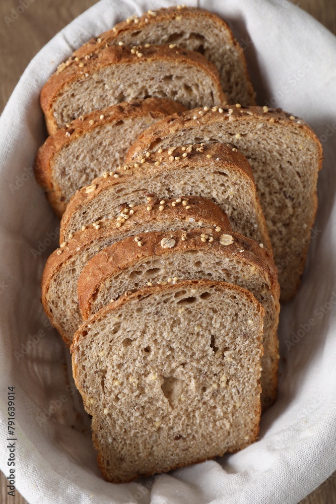 Slices of fresh bread in basket on table, above view Slices of fresh bread in basket on table, above view