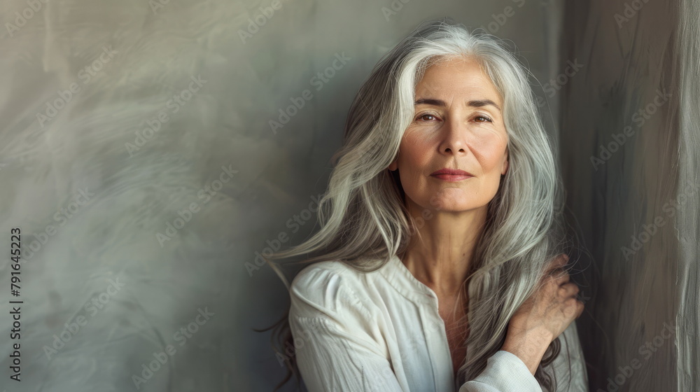 Fototapeta premium Mature female portrait with a gaze that tells a story. Great for themes of experience, life stories.