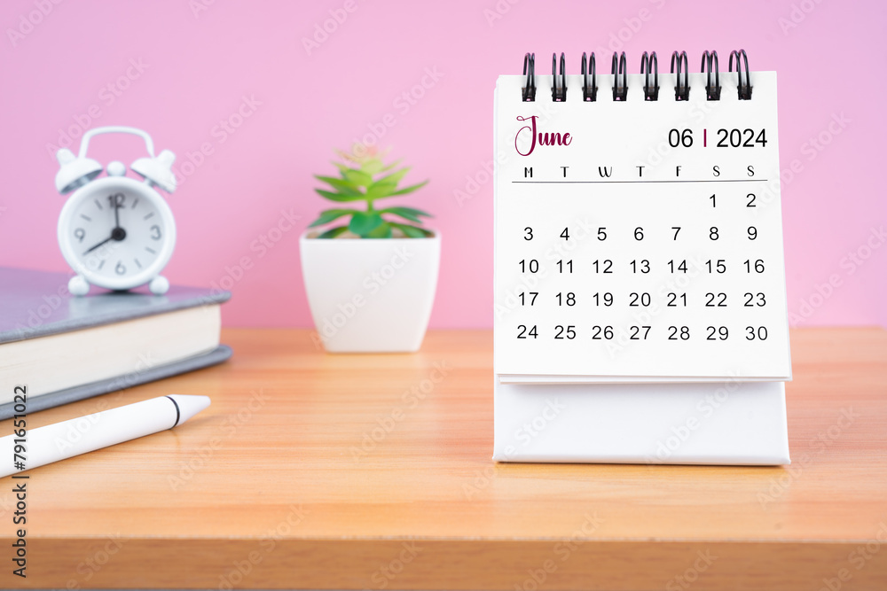 June Mini desk calendar for 2024 year on worktable. - obrazy, fototapety, plakaty 