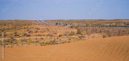 Trucks on the A380 highway driving through the Kyzylkum Desert, Khorezm, Uzbekistan, Central Asia
