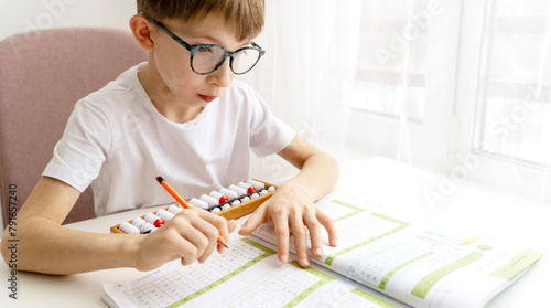 boy student doing mental arithmetic on the abacus
