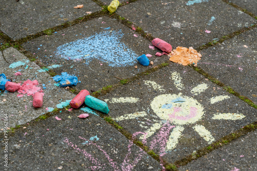 Chalk art on pavement with colorful pieces photo