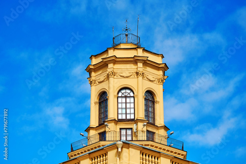 Octagonal three-tier belvedere against blue sky. Stalinist architecture. The building was built in 1945-1947. View on tower of historic building. Scenic view photo