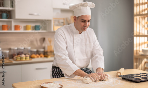 Professional chef kneads dough with expertise. Art of bread-making in a bustling commercial kitchen