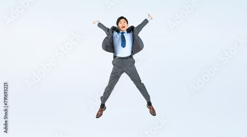 ジャンプする男性ビジネスパーソンの全身写真（切り抜き背景透過PNGも販売しております。作成者リンクから「PNG」で検索してください）