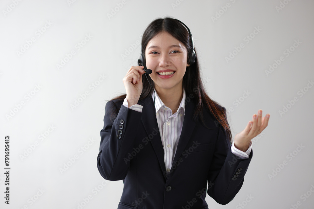 Smiling Asian businesswoman wearing headphones and microphon, headset. Smiling Asian businesswoman wearing headphones and microphon, headset.