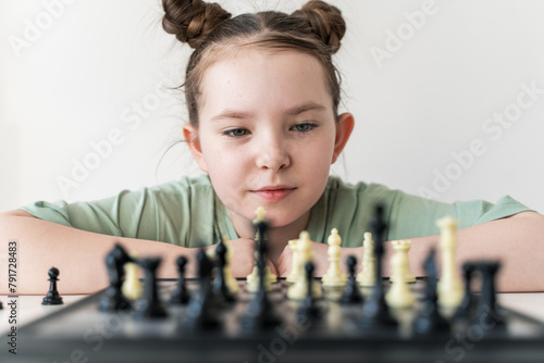 Little girl playing chess. Selected Focus