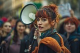A woman with fiery red hair holds a black megaphone, poised to address a crowd with determination and authority