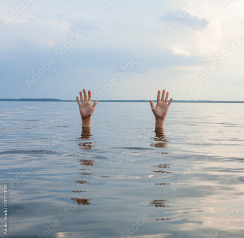 Hands sticking out of water.