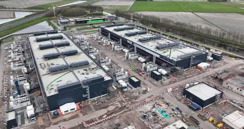 Aerial drone views the construction of a large scale big tech datacenter at Agriport, The Netherlands. Internet cloud and artifical intellgience infrastructure. Investement in data driven technology. photo
