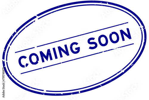 Grunge blue coming soon word oval rubber stamp in white background