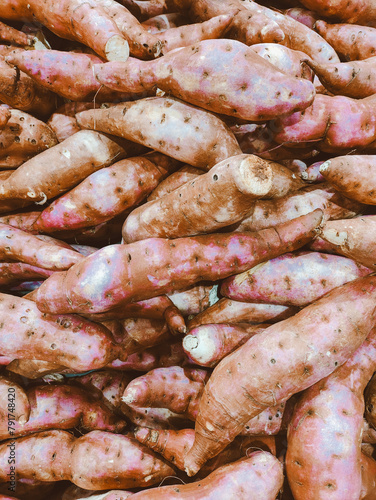 Top view of sweet potatoes exposed in a supermarket. Close up of organic food.