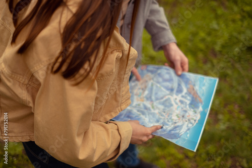 A close-up of a hand holding a map, highlighting cartographic and geographic services, hiking, tourist activities, and location search. photo