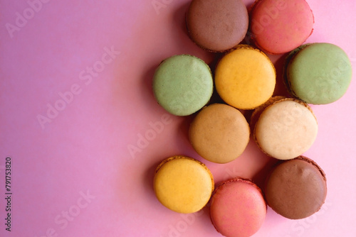 Colorful macarons on pink background. Top view.