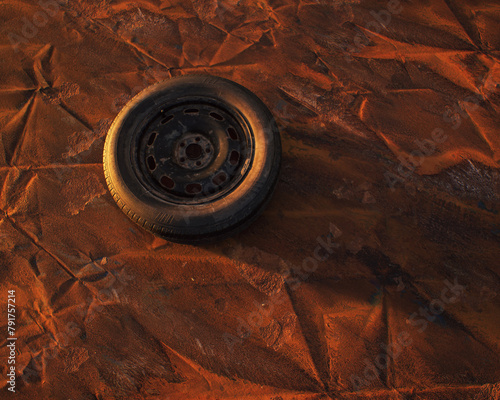 Old car wheel on weathered rusty painted metal sheet. © ysbrandcosijn