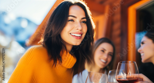 Happy Women Toasting with Red Wine Glasses at Ski Resort. Luxury Vacation Concept. Friendship and Celebration