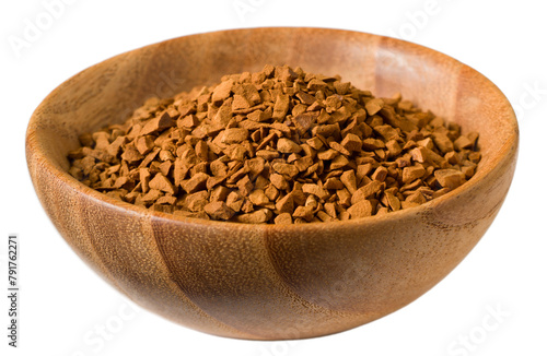 Freeze dried coffee powder in a wooden bowl, isolated on white background.