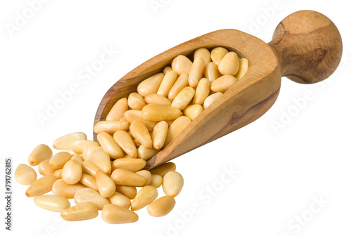 Roasted pine nuts in the wooden scoop, isolated on the white background.