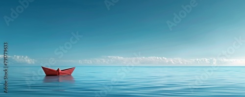 Red paper boat on a calm blue ocean