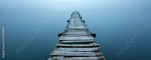 Old wooden pier extending into misty lake