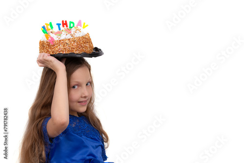 Little girl holding birthday cake on her head, isolated on white background.