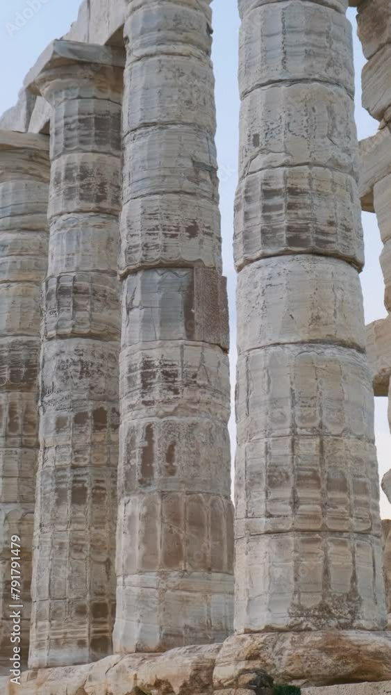 Columns of Temple of Poseidon on Cape Sounion, Attica, Greece. Ancient Greek architecture. Ruins of ancient temple with colonnade of Greek god of the sea. Vertical orientation. Columns of Temple of Poseidon on Cape Sounion, Attica, Greece. Ancient Greek architecture. Ruins of ancient temple with colonnade of Greek god of the sea. Vertical orientation.